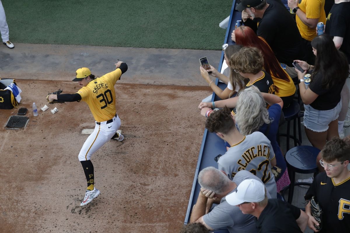 Aug 16, 2024; Pittsburgh, Pennsylvania, USA;  Fans look on as Pittsburgh Pirates starting pitcher Paul Skenes (30) warms up in the bullpen before pitching against the Seattle Mariners at PNC Park. Mandatory Credit: Charles LeClaire-Imagn Images