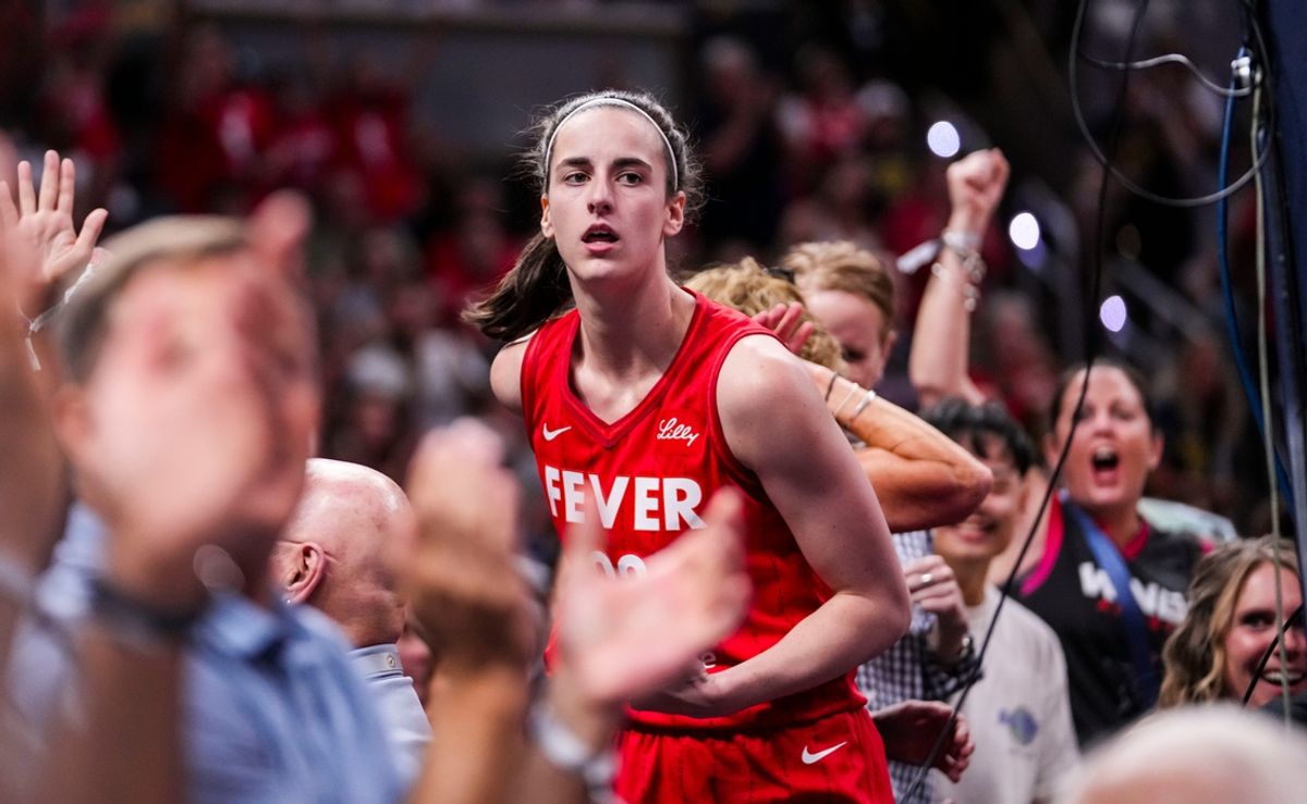 Indiana Fever guard Caitlin Clark (22) celebrates with fans behind the basket Friday, Aug. 16, 2024, during the game at Gainbridge Fieldhouse in Indianapolis.
