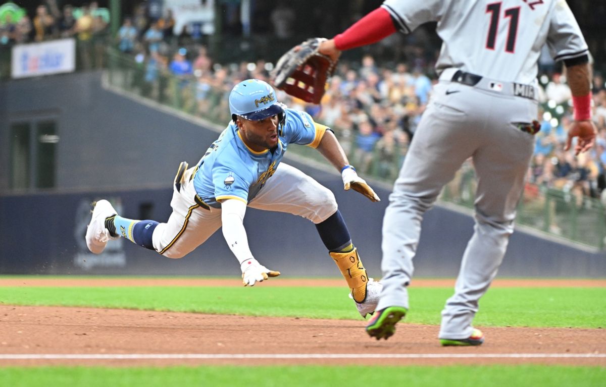 Aug 16, 2024; Milwaukee, Wisconsin, USA; Milwaukee Brewers outfielder Jackson Chourio (11) slides into third base for a triple against the Cleveland Guardians in the first inning  at American Family Field. Mandatory Credit: Michael McLoone-USA TODAY Sports