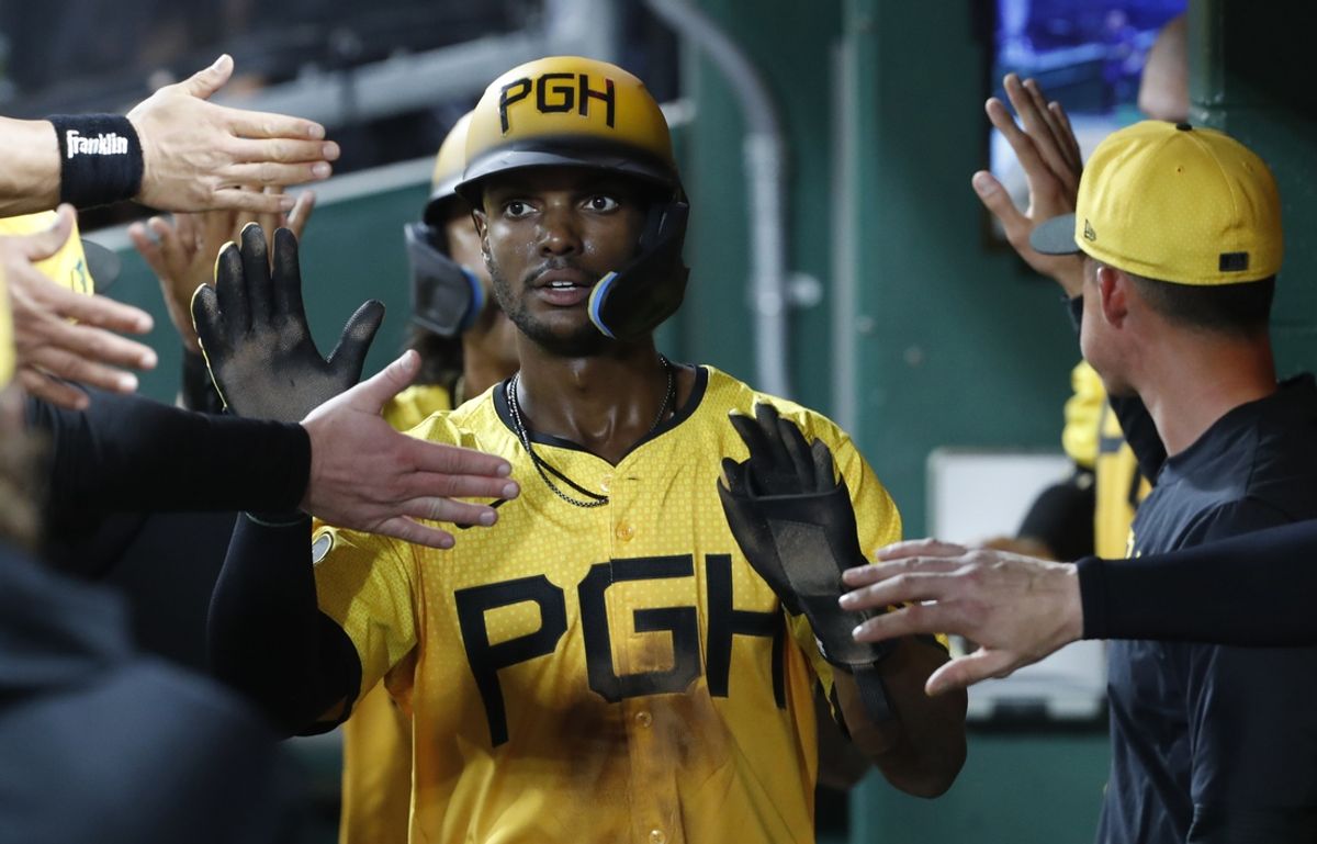 Aug 16, 2024; Pittsburgh, Pennsylvania, USA;  Pittsburgh Pirates center fielder Michael A. Taylor (18) high-fives in the dugout after scoring a run against the Seattle Mariners during the seventh inning at PNC Park. Mandatory Credit: Charles LeClaire-Imagn Images