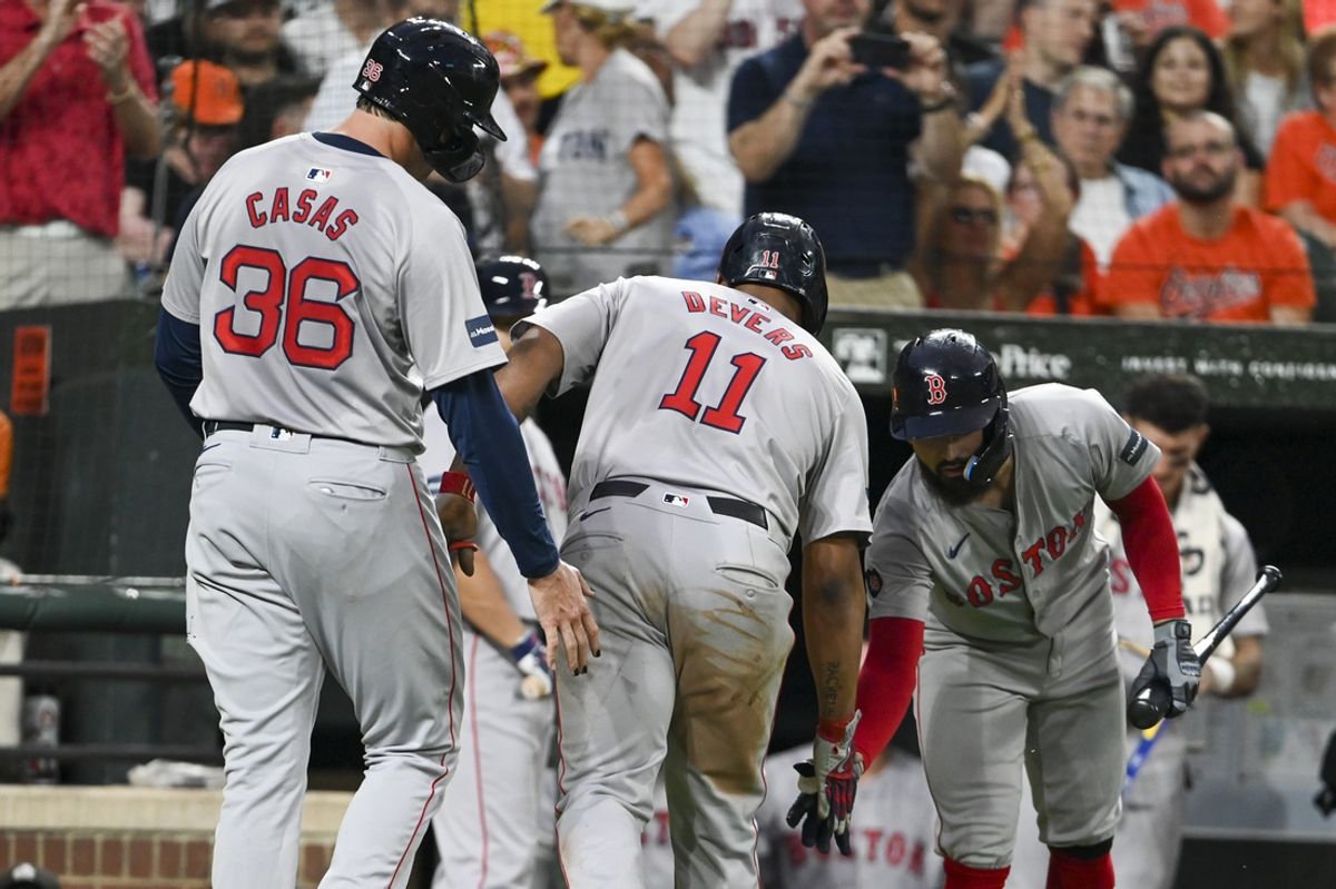 Aug 16, 2024; Baltimore, Maryland, USA;  ]Boston Red Sox third baseman Rafael Devers (11) celebrates with teammates after a third inning two runs home run against the Baltimore Orioles at Oriole Park at Camden Yards. Mandatory Credit: Tommy Gilligan-USA TODAY Sports