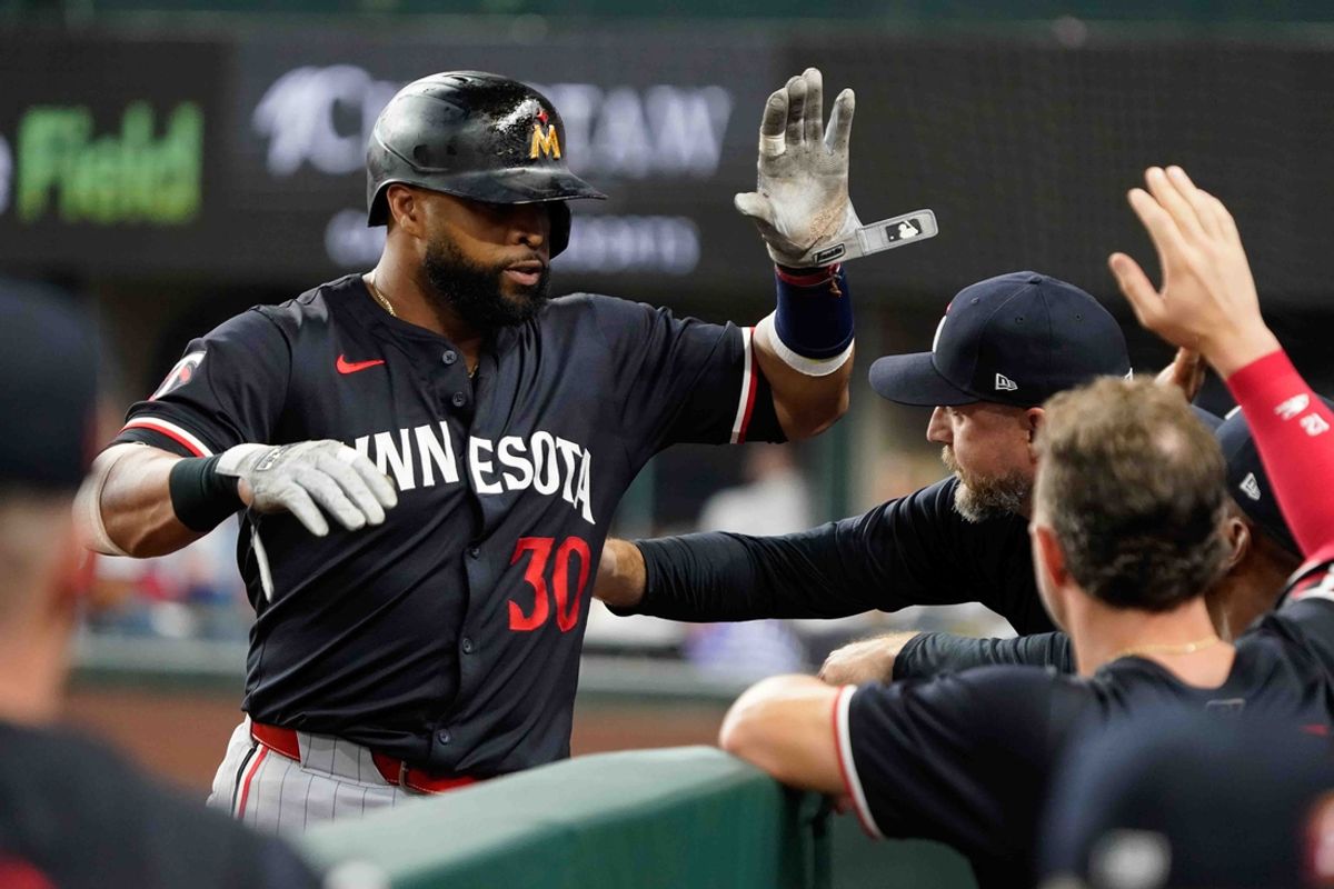 Aug 16, 2024; Arlington, Texas, USA; Minnesota Twins first baseman Carlos Santana (30) is greeted at the dugout stairs after hitting a three-run home run during the fifth inning against the Texas Rangers at Globe Life Field. Mandatory Credit: Raymond Carlin III-USA TODAY Sports