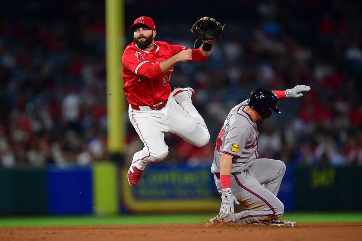August 16, 2024; Anaheim, California, USA; Atlanta Braves left fielder Jarred Kelenic (24) is out at second as Los Angeles Angels second baseman Michael Stefanic (38) throws to first for the out against right fielder Ramon Laureano (18) during the sixth inning at Angel Stadium. Mandatory Credit: Gary A. Vasquez-USA TODAY Sports