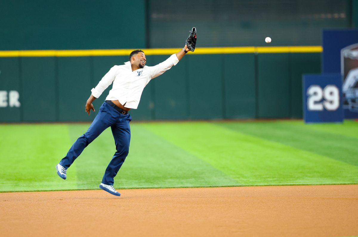 Aug 17, 2024; Arlington, Texas, USA;  Texas Rangers former player Elvis Andrus cannot catch a throw from Hall of Fame player Adrian Beltre (Not pictured) before the game against the Minnesota Twins at Globe Life Field. Mandatory Credit: Kevin Jairaj-Imagn Images