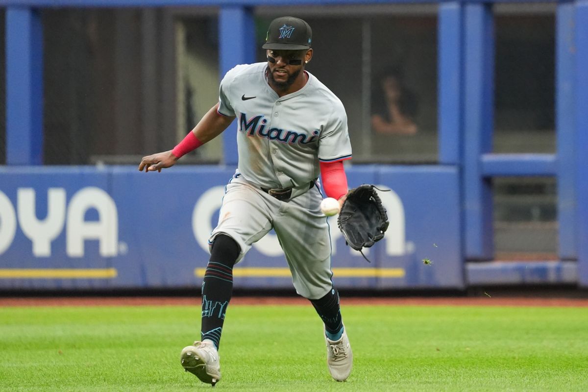 Aug 17, 2024; New York City, New York, USA; Miami Marlins right fielder Vidal Brujan (17) pulls in a ball during the game against the New York Mets at Citi Field. Mandatory Credit: Lucas Boland-Imagn Images