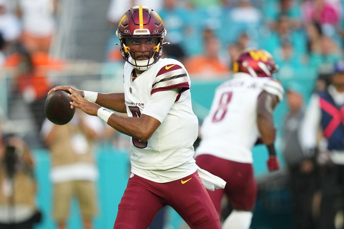 Aug 17, 2024; Miami Gardens, Florida, USA;  Washington Commanders quarterback Jayden Daniels (5) drops back to pass against the Miami Dolphins during the first quarter at Hard Rock Stadium. Mandatory Credit: Jim Rassol-Imagn Images