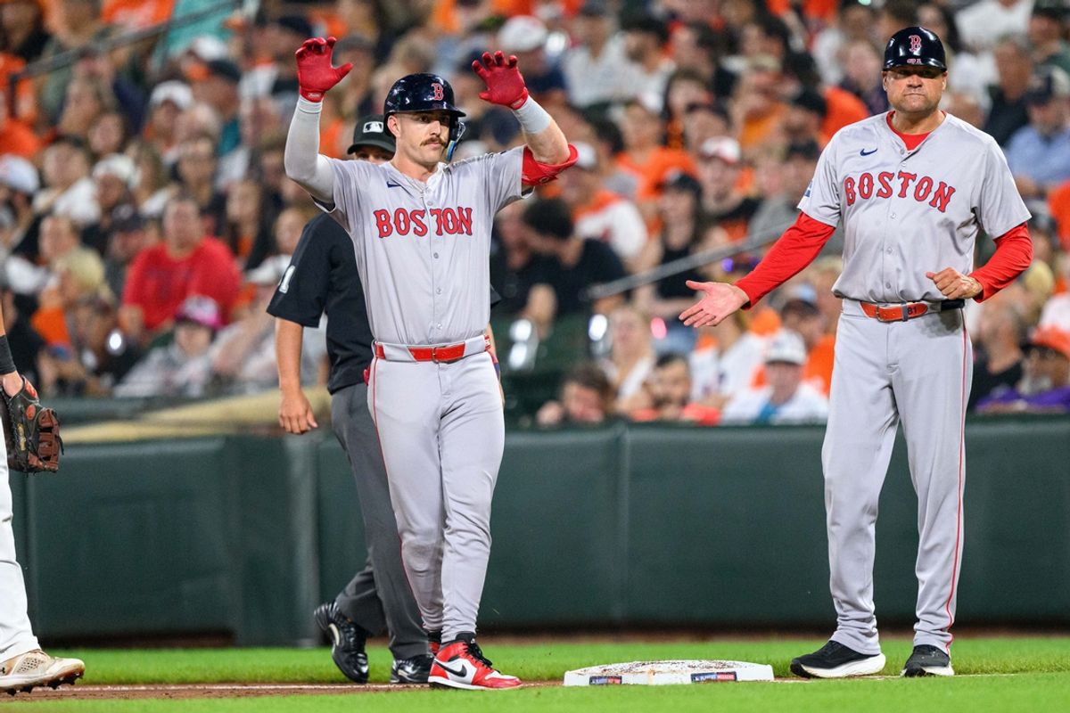 Aug 17, 2024; Baltimore, Maryland, USA; Boston Red Sox first baseman Romy Gonzalez (23) reacts with Boston Red Sox first base coach Andy Fox (81) after hitting a single during the second inning against the Baltimore Orioles at Oriole Park at Camden Yards. Mandatory Credit: Reggie Hildred-USA TODAY Sports