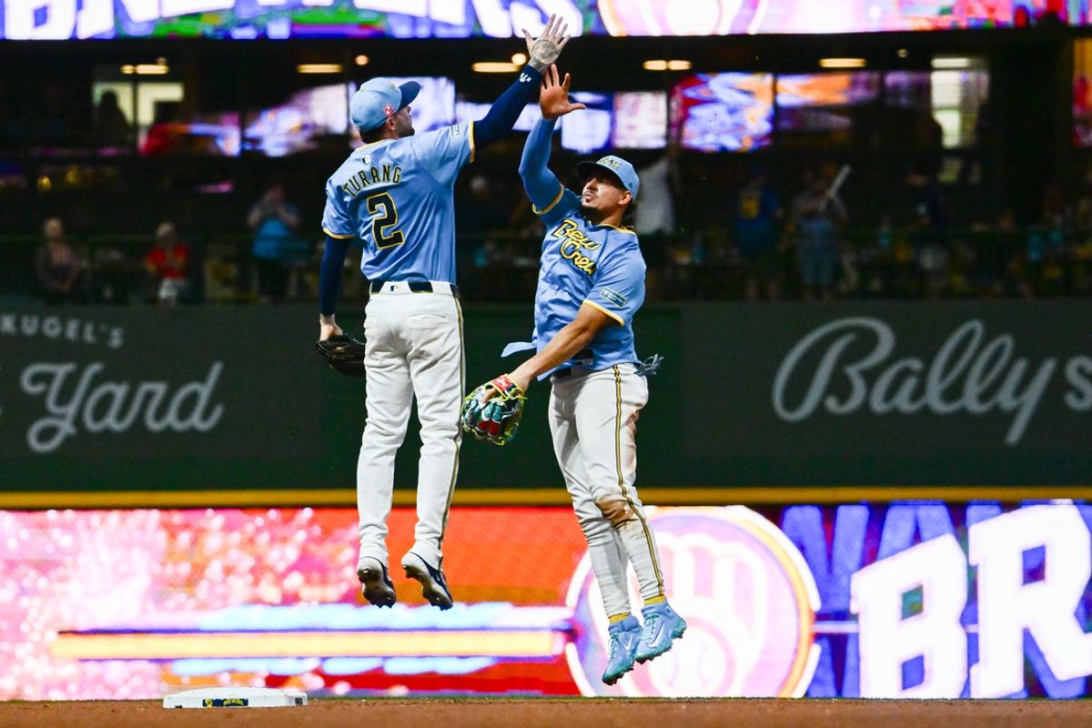 Aug 17, 2024; Milwaukee, Wisconsin, USA; Milwaukee Brewers shortstop Willy Adames (27) and second baseman Brice Turang (2) celebrates after beating Cleveland Guardians at American Family Field. Mandatory Credit: Benny Sieu-USA TODAY Sports