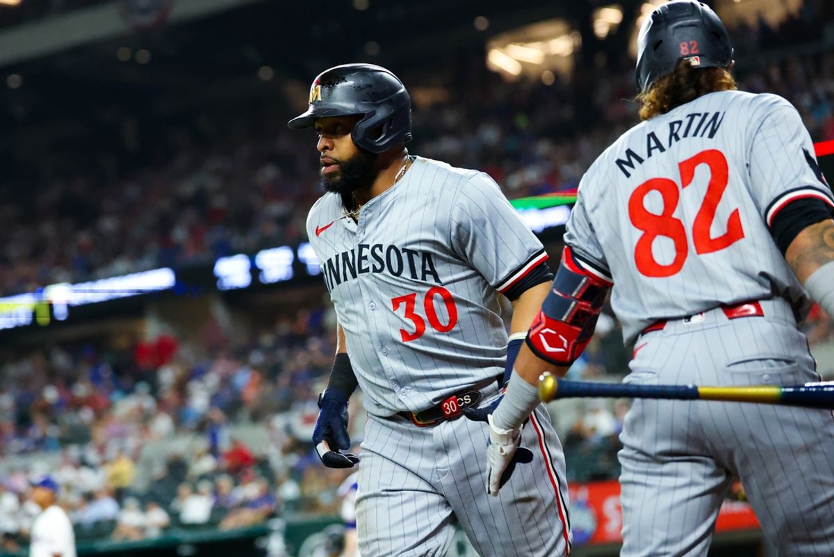 Aug 17, 2024; Arlington, Texas, USA;  Minnesota Twins first baseman Carlos Santana (30) celebrates with Minnesota Twins center fielder Austin Martin (82) after scoring during the ninth inning against the Texas Rangers at Globe Life Field. Mandatory Credit: Kevin Jairaj-USA TODAY Sports