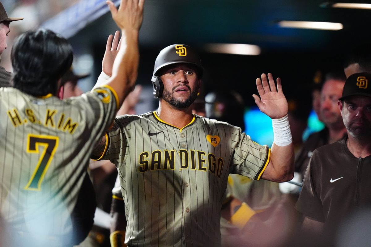 Aug 17, 2024; Denver, Colorado, USA; San Diego Padres outfielder David Peralta (24) celebrates scoring in the sixth inning against the Colorado Rockies at Coors Field. Mandatory Credit: Ron Chenoy-USA TODAY Sports