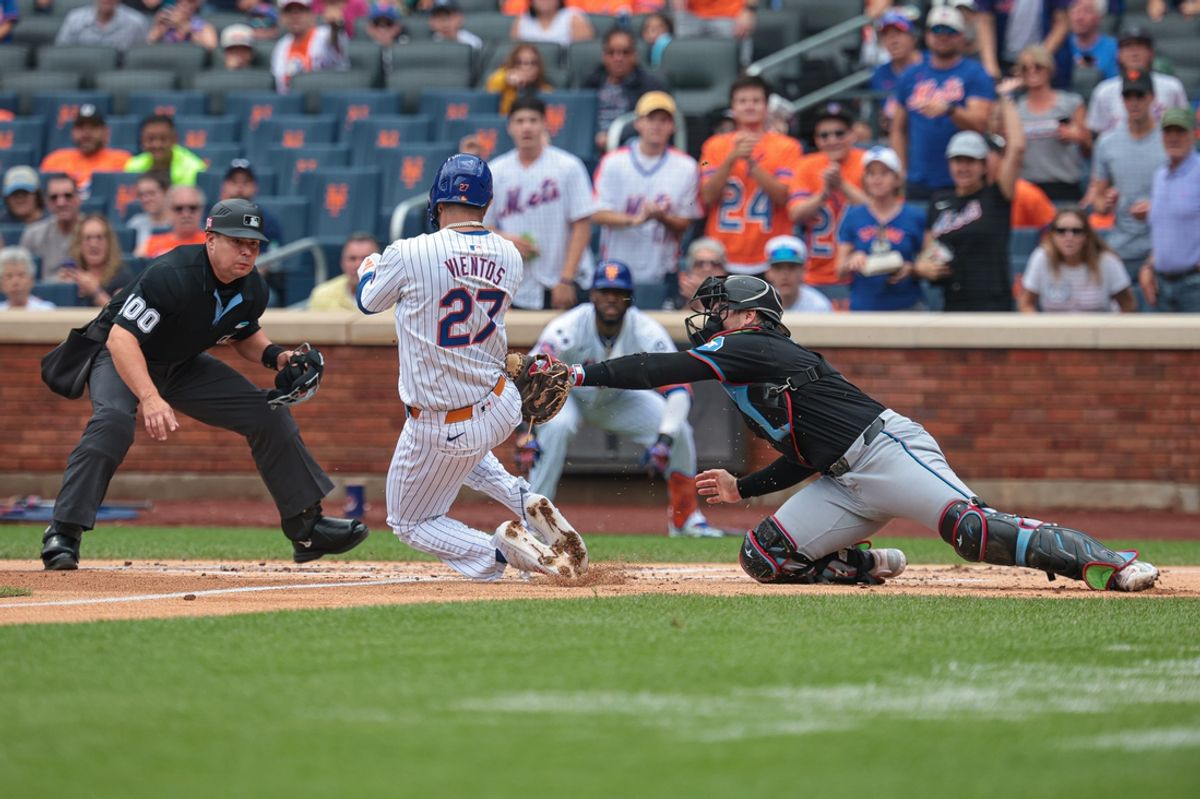 Aug 18, 2024; New York City, New York, USA; Miami Marlins catcher Nick Fortes (4) tags out New York Mets third baseman Mark Vientos (27) at home plate during the first inning at Citi Field. Mandatory Credit: Vincent Carchietta-USA TODAY Sports