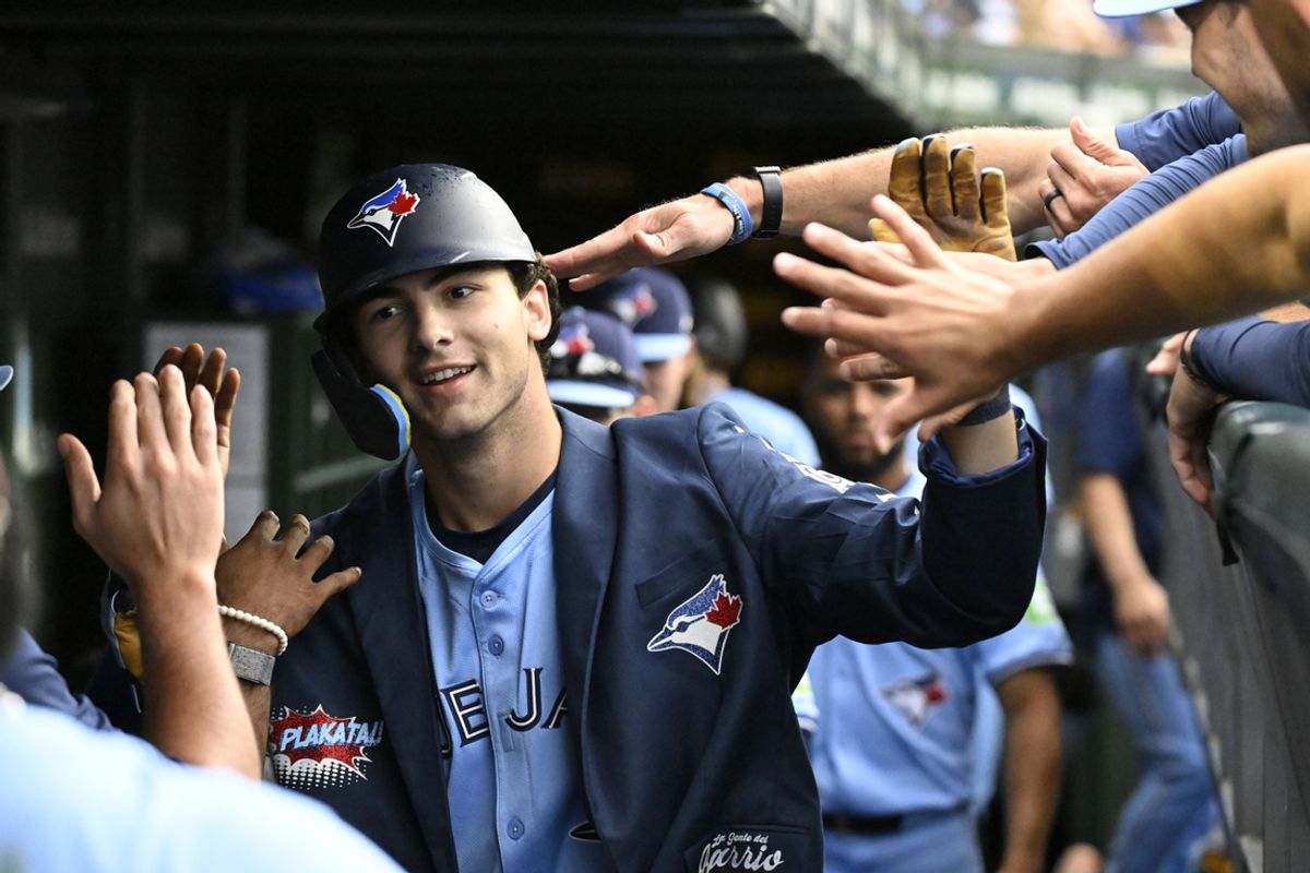 Aug 18, 2024; Chicago, Illinois, USA;  Toronto Blue Jays outfielder Joey Loperfido (9) celebrates in the dugout after hitting a home run against the Chicago Cubs during the second inning at Wrigley Field. Mandatory Credit: Matt Marton-USA TODAY Sports
