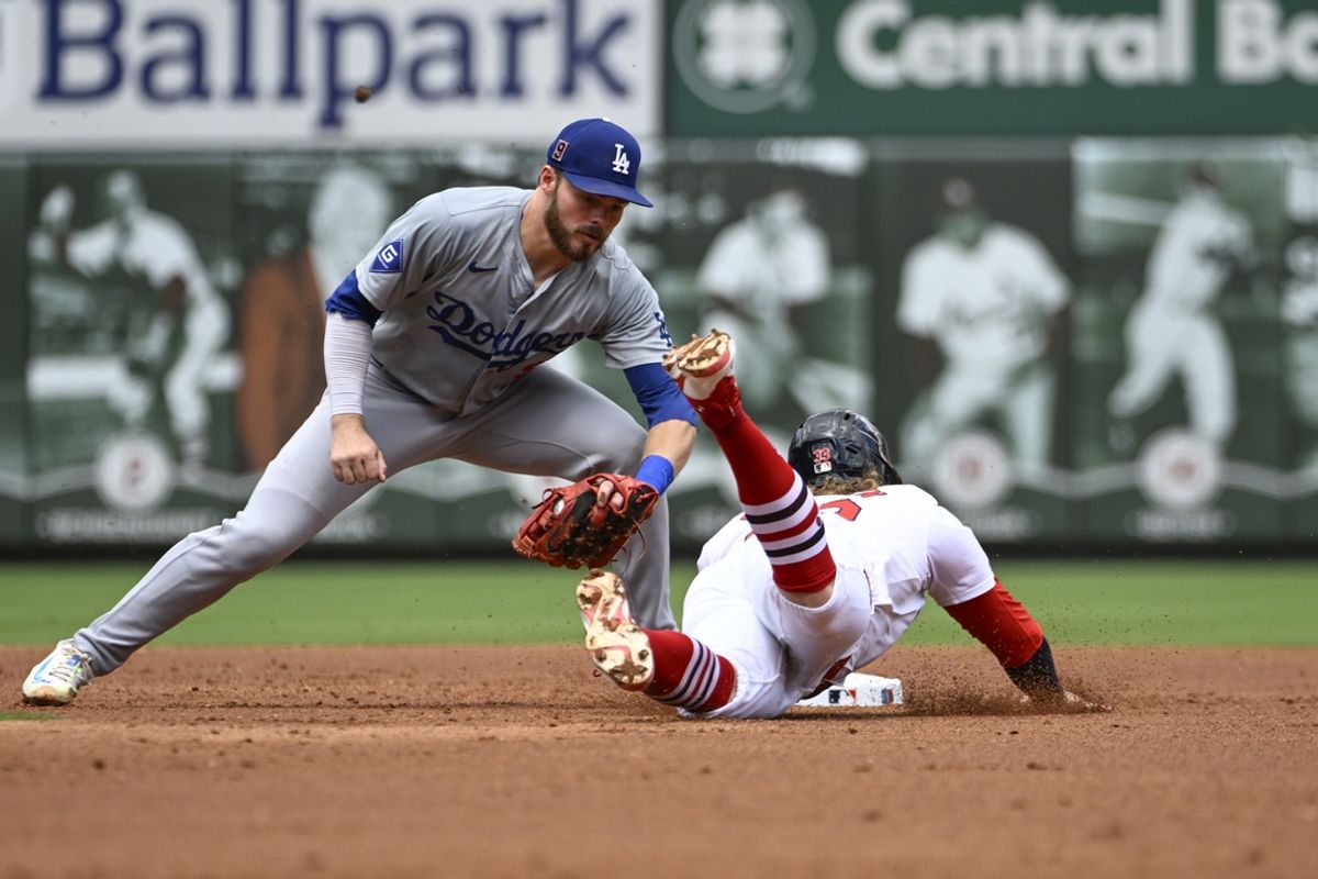 Aug 18, 2024; St. Louis, Missouri, USA; St. Louis Cardinals second baseman Brendan Donovan (33) is tagged out stealing second base by Los Angeles Dodgers second baseman Gavin Lux (9) in the second inning at Busch Stadium. Mandatory Credit: Joe Puetz-USA TODAY Sports