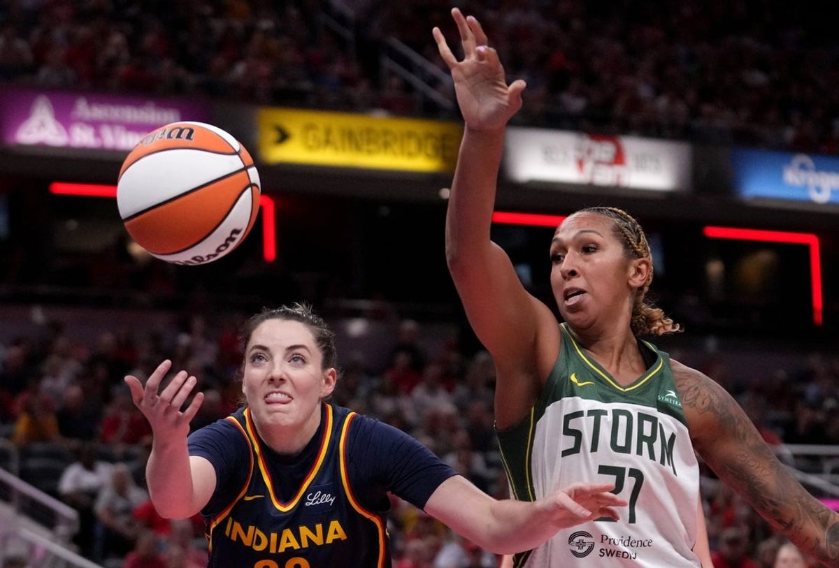 Indiana Fever forward Katie Lou Samuelson (33) and Seattle Storm center Mercedes Russell (21) reach for a ball during the first half of a game Sunday, Aug. 18, 2024, at Gainbridge Fieldhouse in Indianapolis.
