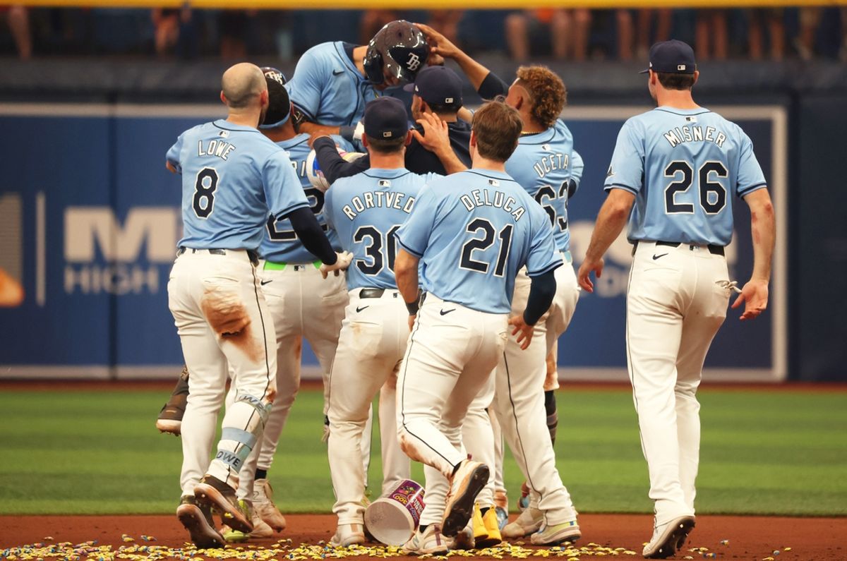 Aug 18, 2024; St. Petersburg, Florida, USA; Tampa Bay Rays outfielder Dylan Carlson (10) is congratulated by third baseman Junior Caminero (13), outfielder Jose Siri (22) nd teammates after he hit a game winning walk off against the Arizona Diamondbacks during the eleventh inning at Tropicana Field. Mandatory Credit: Kim Klement Neitzel-USA TODAY Sports