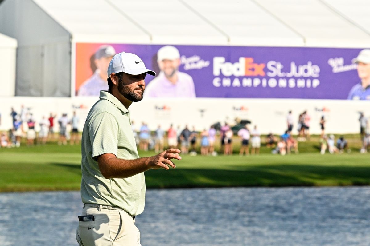 Aug 18, 2024; Memphis, Tennessee, USA; Scottie Scheffler  waves to the crowd on the 18th green during the final round of the FedEx St. Jude Championship golf tournament at TPC Southwind. Mandatory Credit: Steve Roberts-USA TODAY Sports