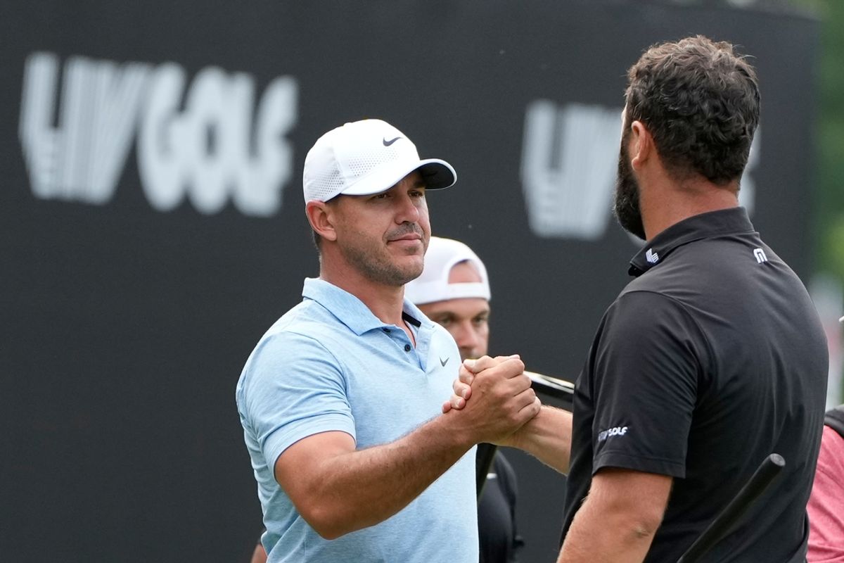 Aug 18, 2024; Greenbrier, West Virginia, USA; Brooks Koepka greets Jon Rahm after winning a playoff against him at The Old White at the Greenbrier. Mandatory Credit: Bob Donnan-Imagn Images