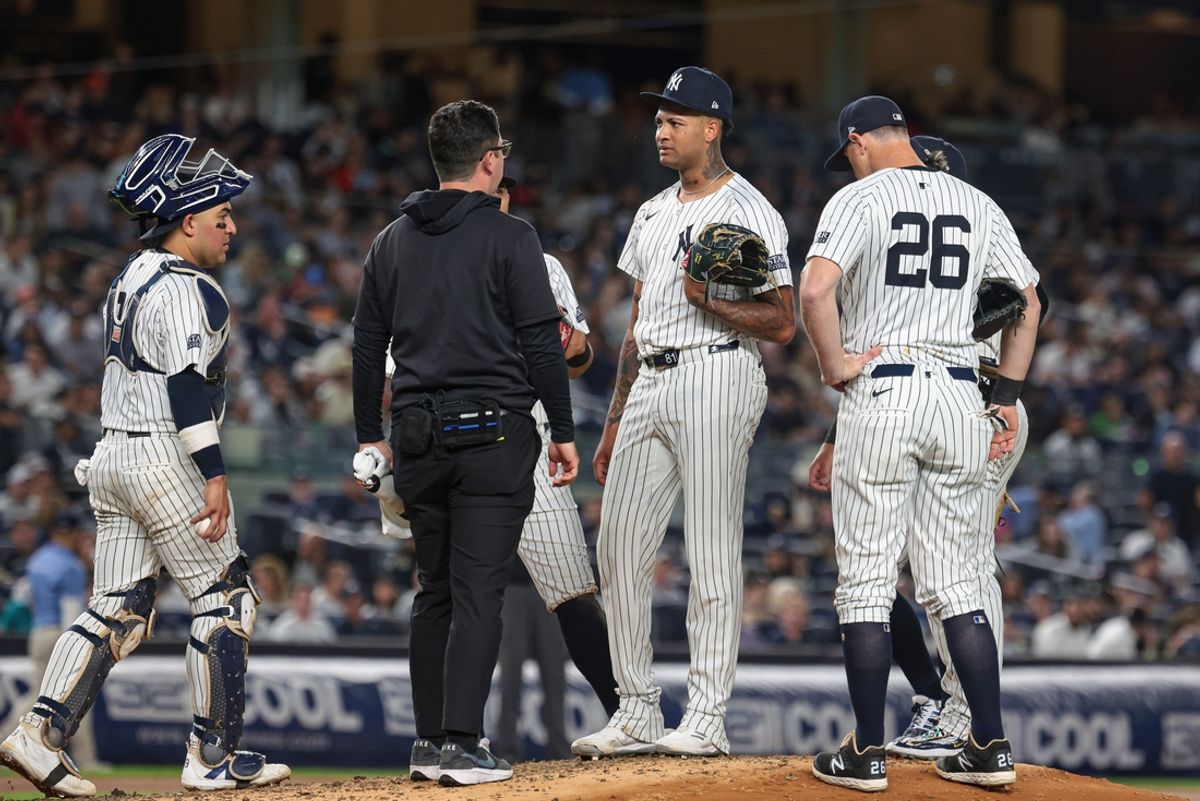 Aug 20, 2024; Bronx, New York, USA; New York Yankees starting pitcher Luis Gil (81) talks with a member of the medical staff before being relieved during the fourth inning against the Cleveland Guardians at Yankee Stadium. Mandatory Credit: Vincent Carchietta-Imagn Images