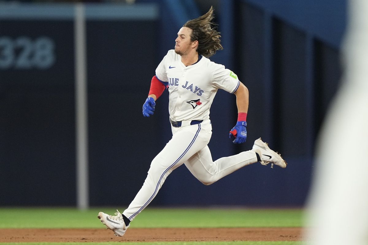 Aug 20, 2024; Toronto, Ontario, CAN; Toronto Blue Jays right fielder Addison Barger (47) runs to second base on his one-run double against the Cincinnati Reds during the second inning at Rogers Centre. Mandatory Credit: John E. Sokolowski-USA TODAY Sports