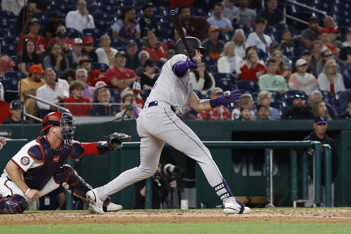 Aug 20, 2024; Washington, District of Columbia, USA; Colorado Rockies outfielder Nolan Jones (22) hits an RBI single against the Washington Nationals during the sixth inning at Nationals Park. Mandatory Credit: Geoff Burke-USA TODAY Sports
