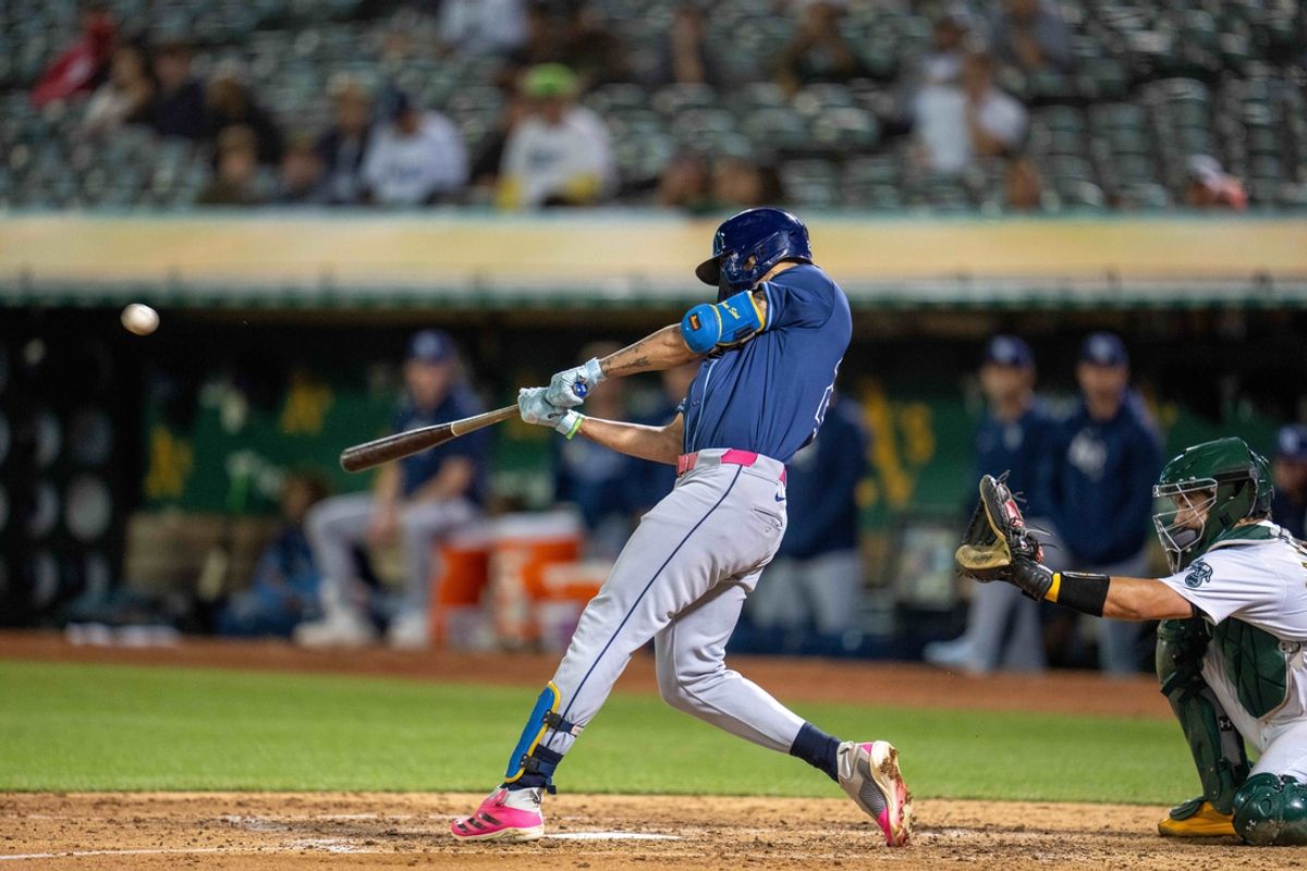 Aug 20, 2024; Oakland, California, USA; Tampa Bay Rays center fielder Jose Siri (22) hits a solo home run during the eighth inning against the Oakland Athletics at Oakland-Alameda County Coliseum. Mandatory Credit: Neville E. Guard-USA TODAY Sports