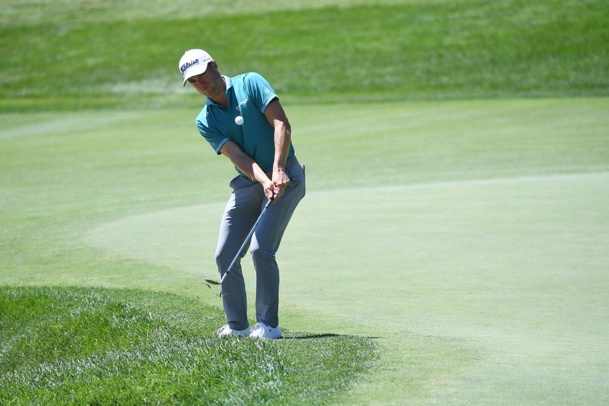 Aug 22, 2024; Castle Rock, Colorado, USA; Justin Thomas hits a chip shot on the ninth hole during the first round of the BMW Championship golf tournament at Castle Pines Golf Club. Mandatory Credit: Christopher Hanewinckel-Imagn Images