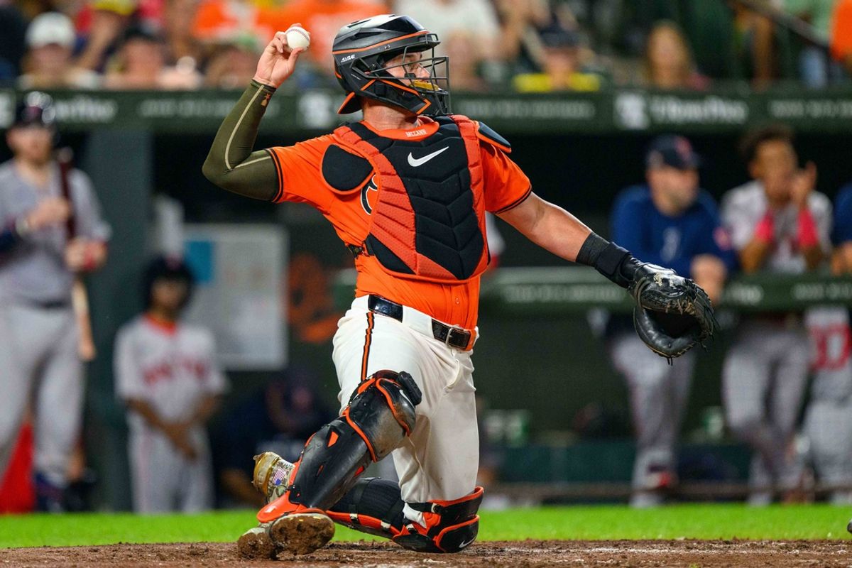 Aug 17, 2024; Baltimore, Maryland, USA; Baltimore Orioles catcher James McCann (27) throws the ball during the fifth inning against the Boston Red Sox at Oriole Park at Camden Yards. Mandatory Credit: Reggie Hildred-Imagn Images