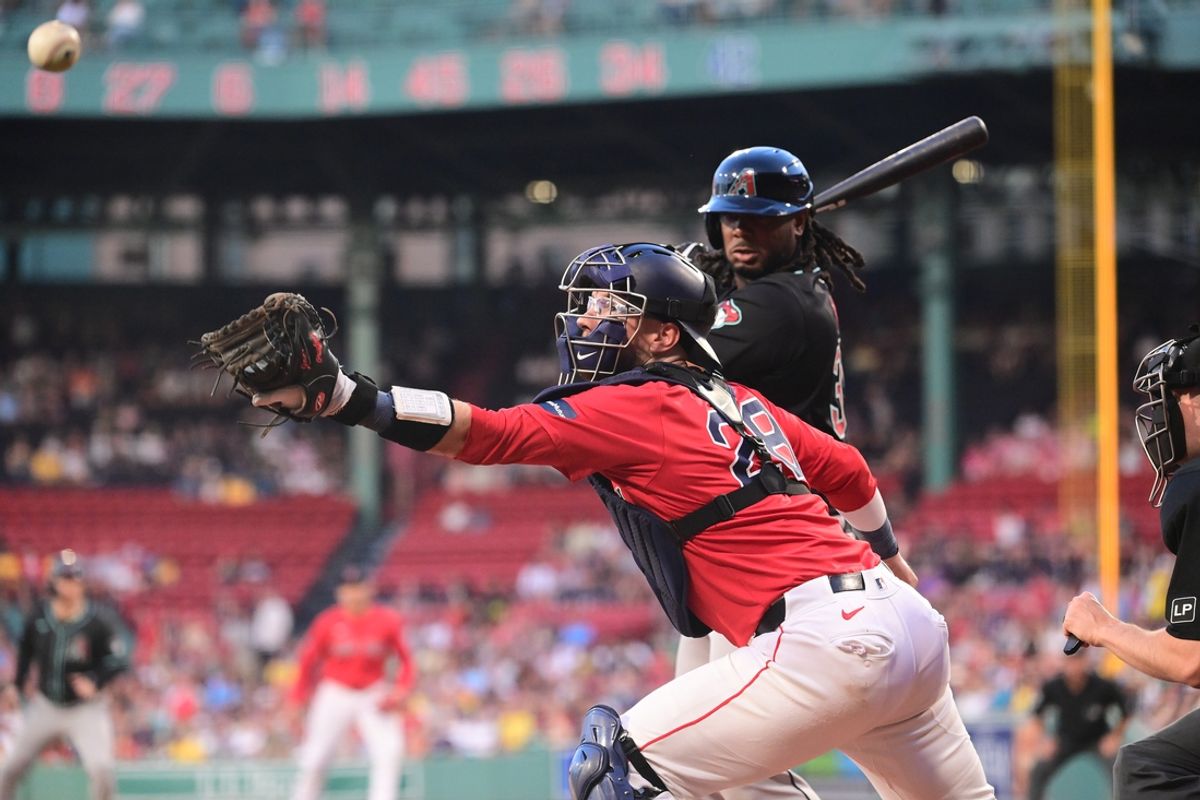 Aug 23, 2024; Boston, Massachusetts, USA; Boston Red Sox catcher Danny Jansen (28) reaches back to try to catch a foul ball during the first inning against the Arizona Diamondbacks at Fenway Park. Mandatory Credit: Eric Canha-USA TODAY Sports