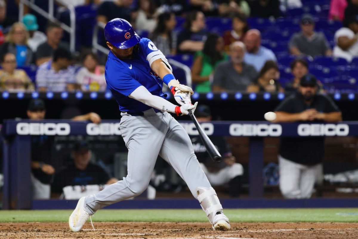 Aug 23, 2024; Miami, Florida, USA; Chicago Cubs designated hitter Seiya Suzuki (27) hits a double against the Miami Marlins during the third inning at loanDepot Park. Mandatory Credit: Sam Navarro-USA TODAY Sports