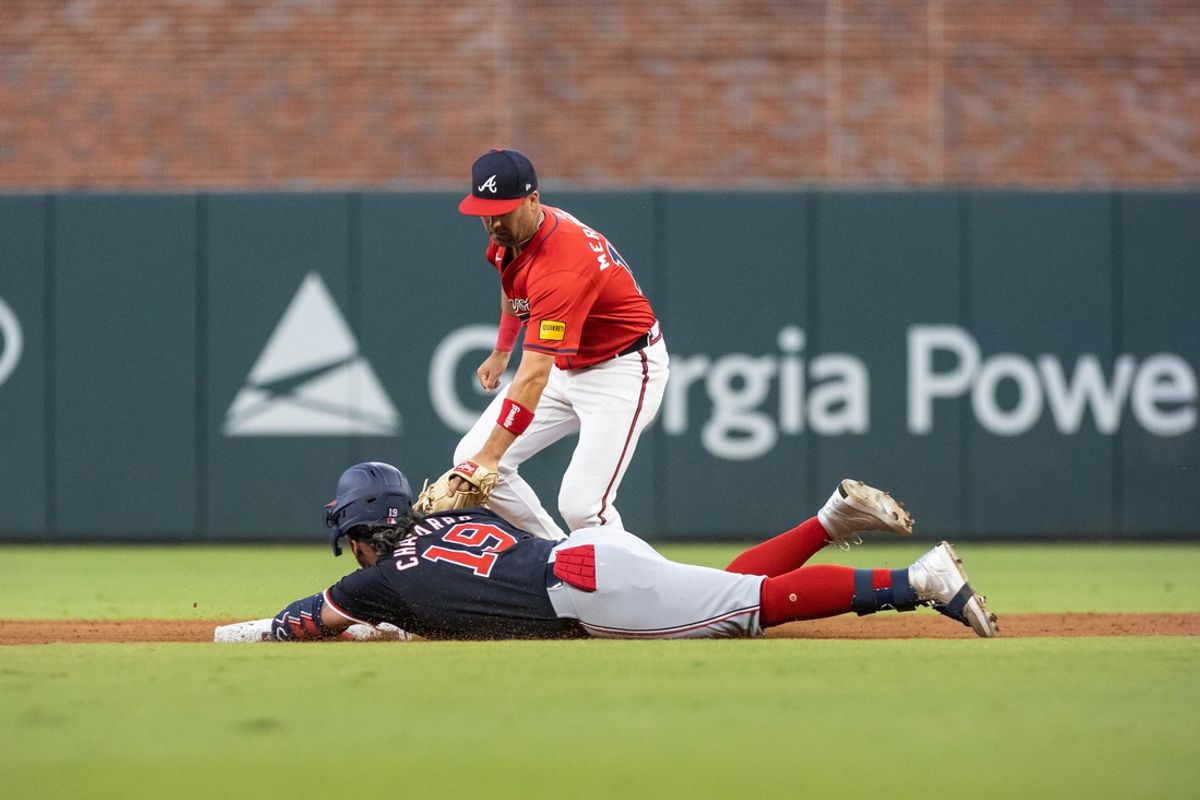 Aug 23, 2024; Cumberland, Georgia, USA; Washington Nationals third base Andres Chaparro (19) slides into second base against Atlanta Braves outfielder Whit Merrifield (15) during the fourth inning at Truist Park. Mandatory Credit: Jordan Godfree-USA TODAY Sports