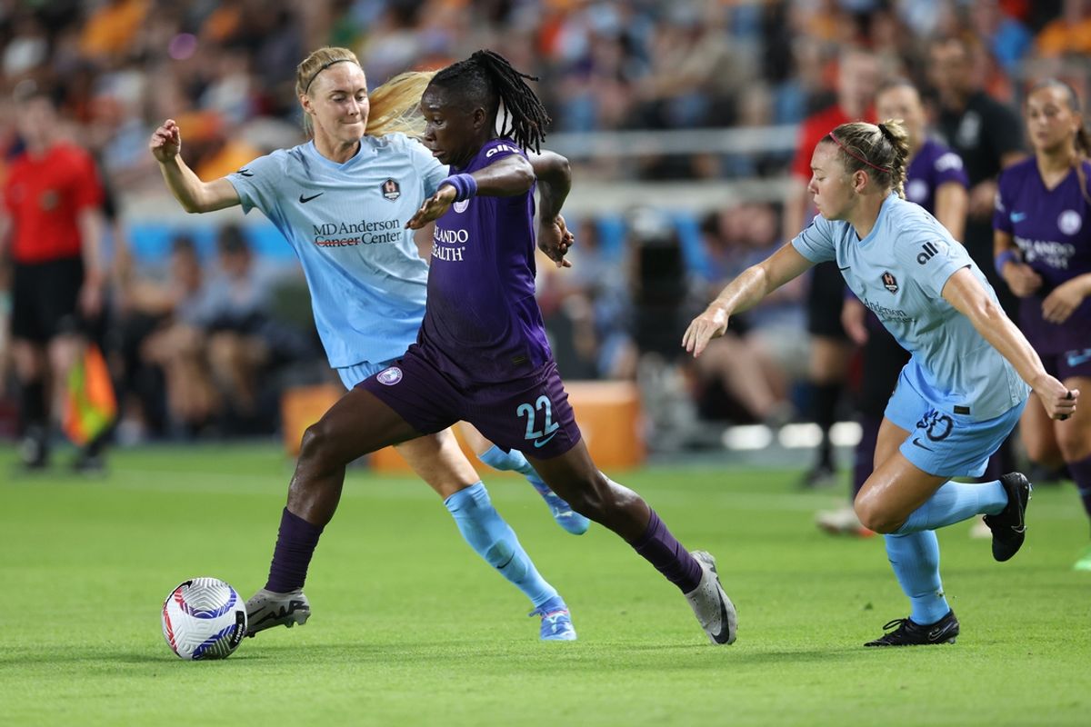 Aug 23, 2024; Houston, Texas, USA; Orlando Pride forward Barbra Banda (22) controls the ball against Houston Dash midfielder Sarah Puntigam (17) in the second half at Shell Energy Stadium. Mandatory Credit: Troy Taormina-USA TODAY Sports