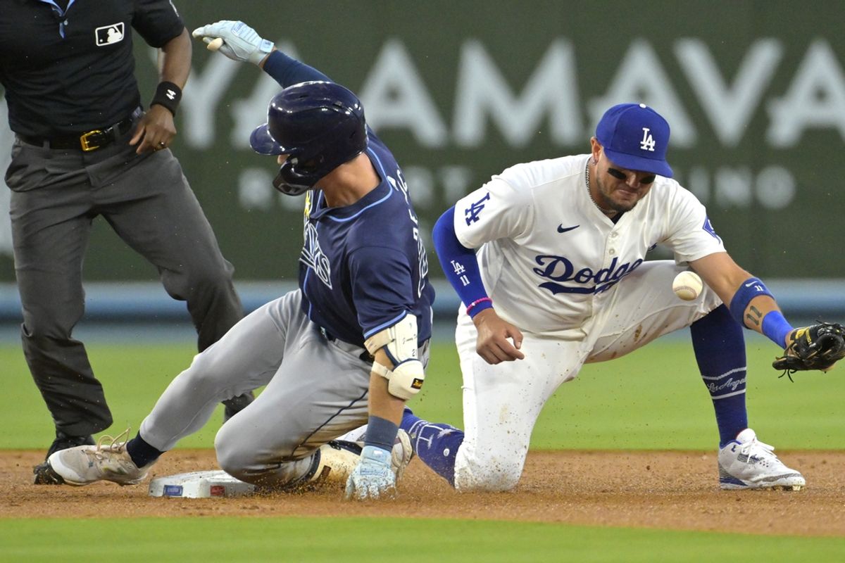 Aug 23, 2024; Los Angeles, California, USA;  Tampa Bay Rays right fielder Jonny DeLuca (21) beats the throw to Los Angeles Dodgers shortstop Miguel Rojas (11) for a double in the second inning at Dodger Stadium. Mandatory Credit: Jayne Kamin-Oncea-USA TODAY Sports