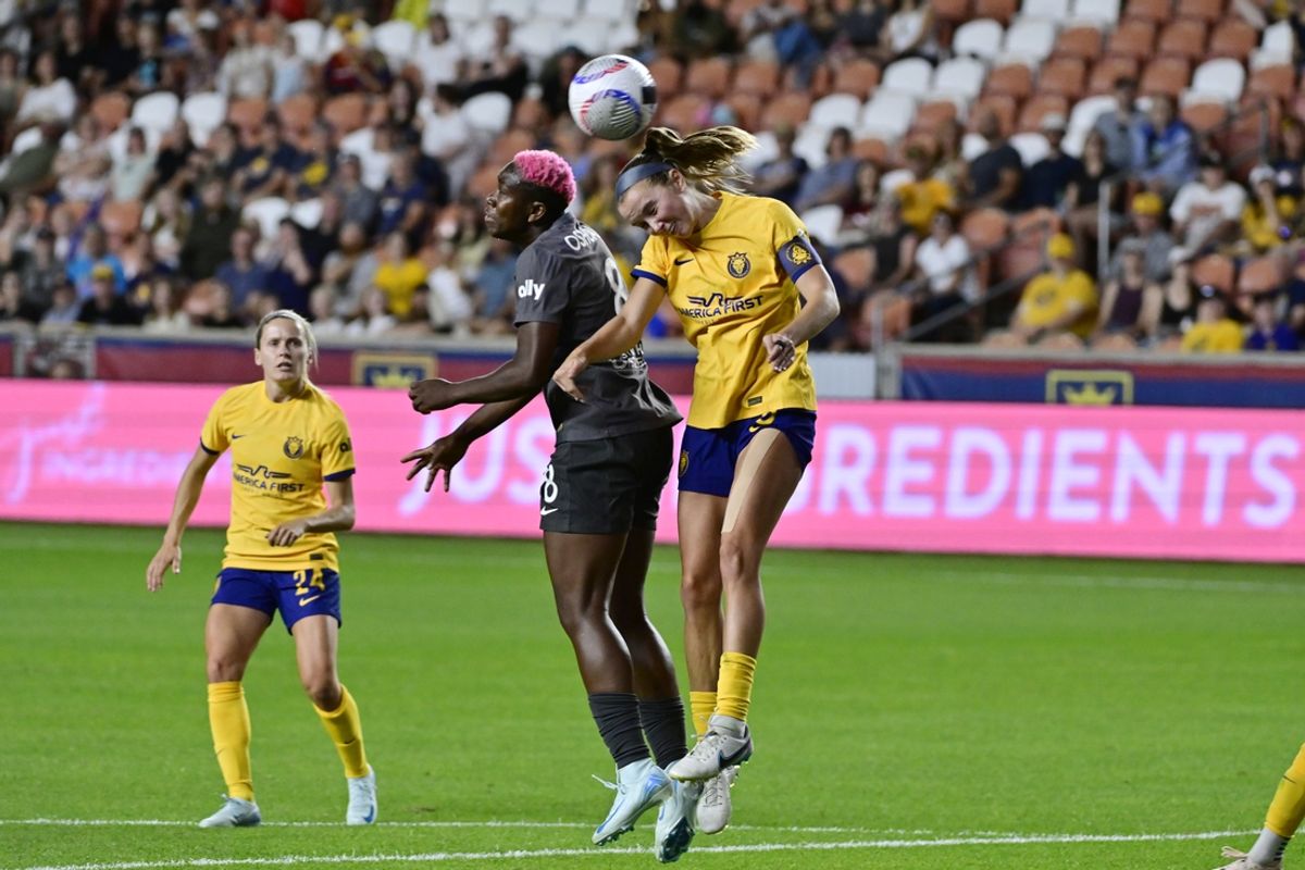 Aug 23, 2024; Sandy, Utah, USA;  Utah Royals FC defender Kate Del Fava (8) heads the ball against Bay FC forward Asisat Oshoala (8) during the second half at America First Field. Mandatory Credit: Peter Creveling-USA TODAY Sports