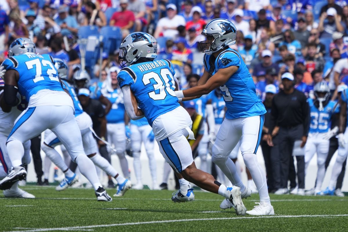 Aug 24, 2024; Orchard Park, New York, USA; Carolina Panthers quarterback Bryce Young (9) hands the ball off to Carolina Panthers running back Chuba Hubbard (30) against the Buffalo Bills during the first half at Highmark Stadium. Mandatory Credit: Gregory Fisher-Imagn Images