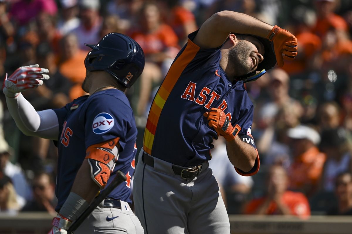 Aug 24, 2024; Baltimore, Maryland, USA;  Houston Astros second baseman Jose Altuve (27) celebrate with a21 after hitting a first inning solo home run against the Baltimore Orioles at Oriole Park at Camden Yards. Mandatory Credit: Tommy Gilligan-USA TODAY Sports