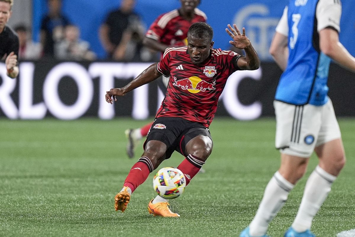 Aug 24, 2024; Charlotte, North Carolina, USA; New York Red Bulls forward Elias Manoel (11) kicks the ball forward against Charlotte FC during the first half at Bank of America Stadium. Mandatory Credit: Jim Dedmon-USA TODAY Sports