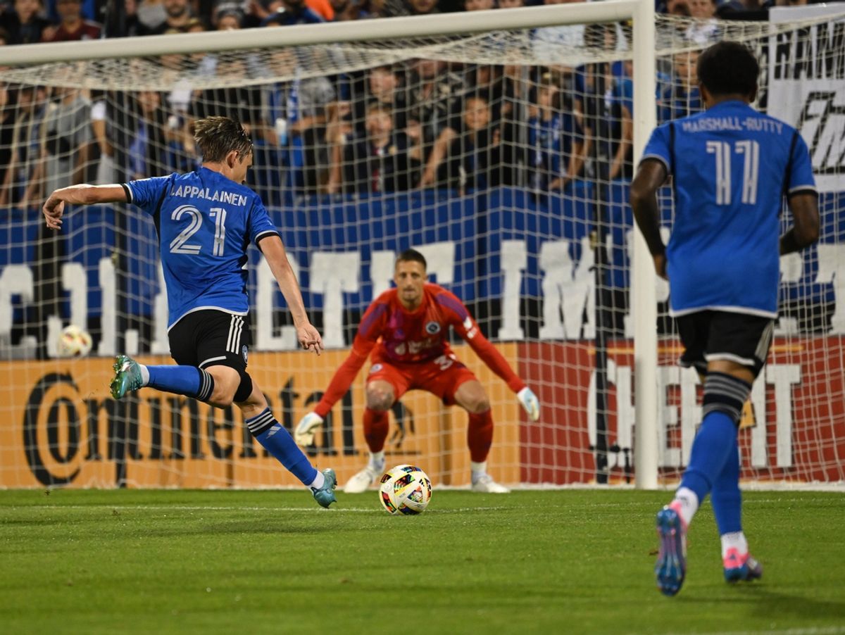 Aug 24, 2024; Montreal, Quebec, CAN; CF Montreal midfielder Lassi Lappalainen (21) shot on goal against New England Revolution goalkeeper Aljaz Ivacic (31) during the second half at Stade Saputo. Mandatory Credit: David Kirouac-USA TODAY Sports