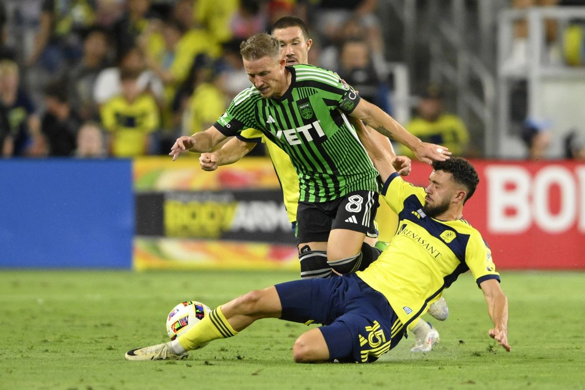 Aug 24, 2024; Nashville, Tennessee, USA; Nashville SC midfielder Patrick Yazbek (15) tackles Austin FC midfielder Alex Ring (8) during the first half at Geodis Park. Mandatory Credit: Steve Roberts-USA TODAY Sports