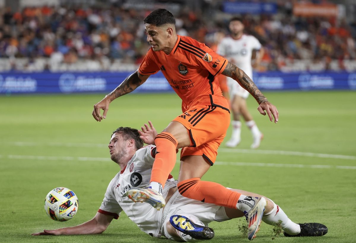 Aug 24, 2024; Houston, Texas, USA;  Houston Dynamo FC defender Franco Escobar (2) dribbles over Toronto FC defender Kevin Long (5) in the first half at Shell Energy Stadium. Mandatory Credit: Thomas Shea-USA TODAY Sports