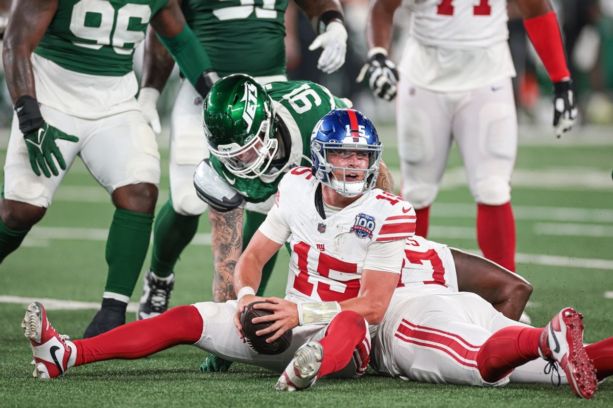 Aug 24, 2024; East Rutherford, New Jersey, USA; New York Giants quarterback Tommy DeVito (15) reacts after being sacked during the second half by New York Jets defensive end Braiden McGregor (91) at MetLife Stadium. Mandatory Credit: Vincent Carchietta-Imagn Images