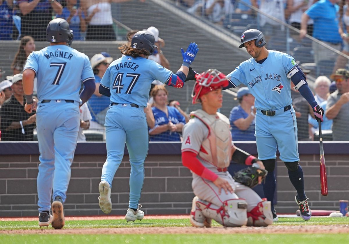 Aug 25, 2024; Toronto, Ontario, CAN; Toronto Blue Jays right fielder Addison Barger (47) hits a two run home run and celebrates with designated hitter George Springer (4) against the Los Angeles Angels during the sixth inning at Rogers Centre. Mandatory Credit: Nick Turchiaro-USA TODAY Sports