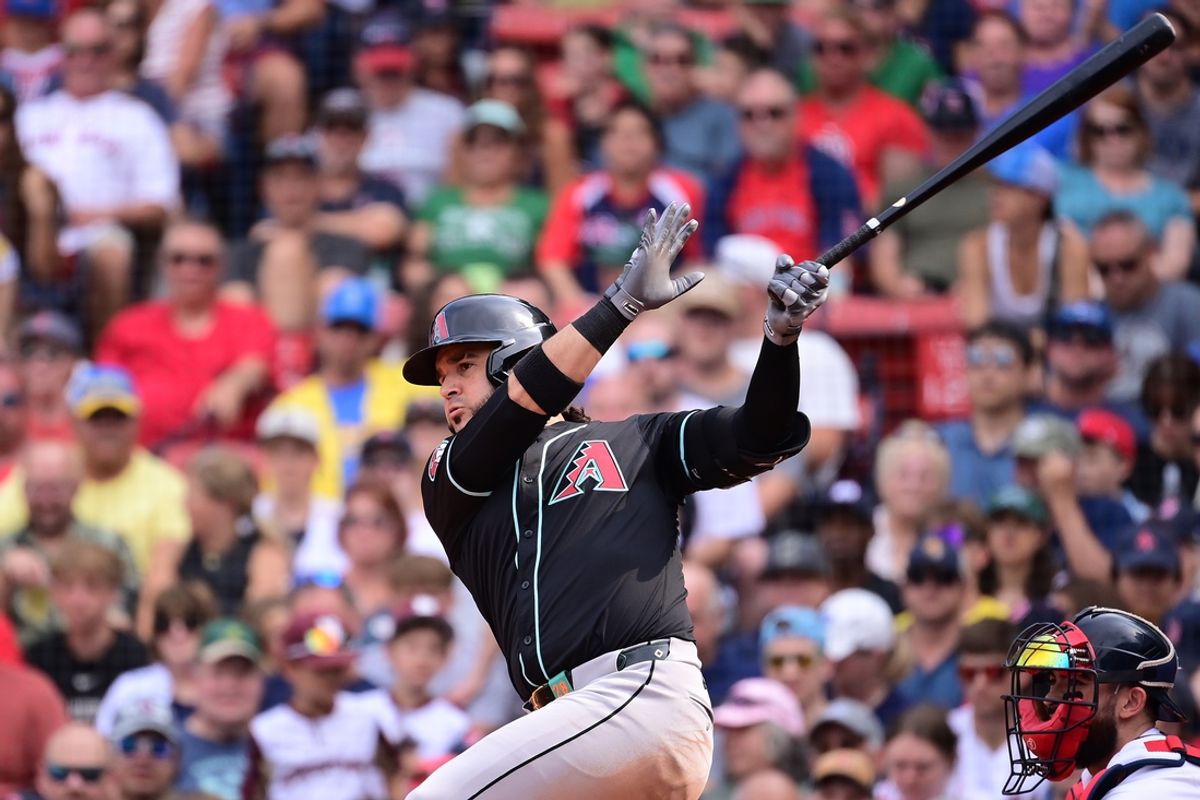 Aug 25, 2024; Boston, Massachusetts, USA; Arizona Diamondbacks third baseman Eugenio Suarez (28) hits a single during the eighth inning against the Boston Red Sox at Fenway Park. Mandatory Credit: Eric Canha-USA TODAY Sports