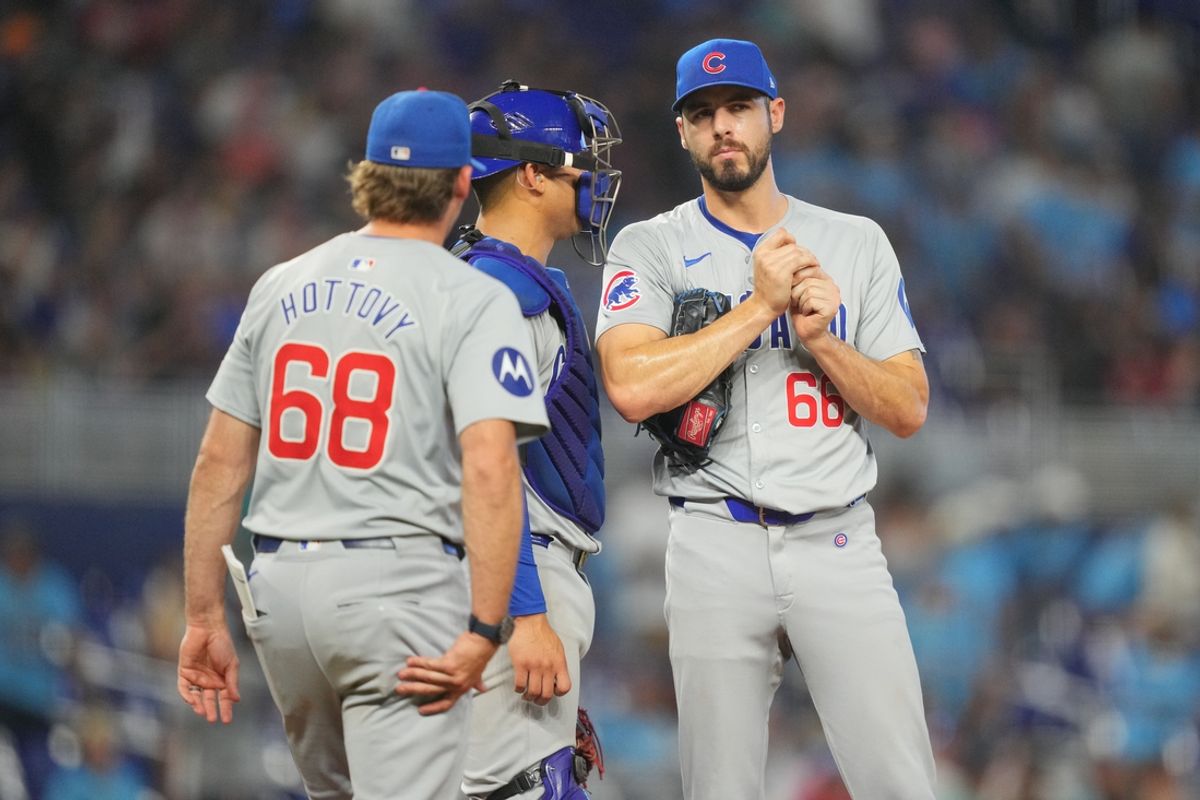 Aug 25, 2024; Miami, Florida, USA;  Chicago Cubs pitcher Julian Merryweather (66) gets a visit from pitching coach Tommy Hottovy (68) in the eighth inning at loanDepot Park. Mandatory Credit: Jim Rassol-USA TODAY Sports