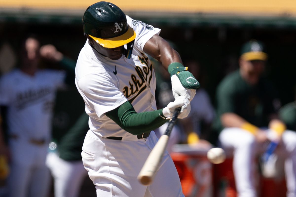 Aug 25, 2024; Oakland, California, USA; Oakland Athletics left fielder Daz Cameron (28) hits a sacrifice fly against the Milwaukee Brewers during the fourth inning at Oakland-Alameda County Coliseum. Mandatory Credit: D. Ross Cameron-Imagn Images