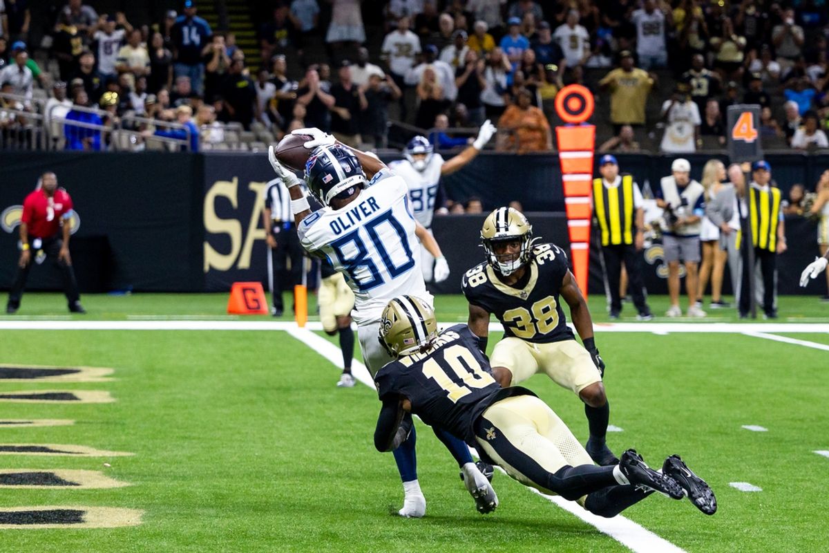 Aug 25, 2024; New Orleans, Louisiana, USA;  Tennessee Titans wide receiver Bryce Oliver (80) catches a touchdown pass against against New Orleans Saints cornerback Joejuan Williams (10) during the second half at Caesars Superdome. Mandatory Credit: Stephen Lew-USA TODAY Sports
