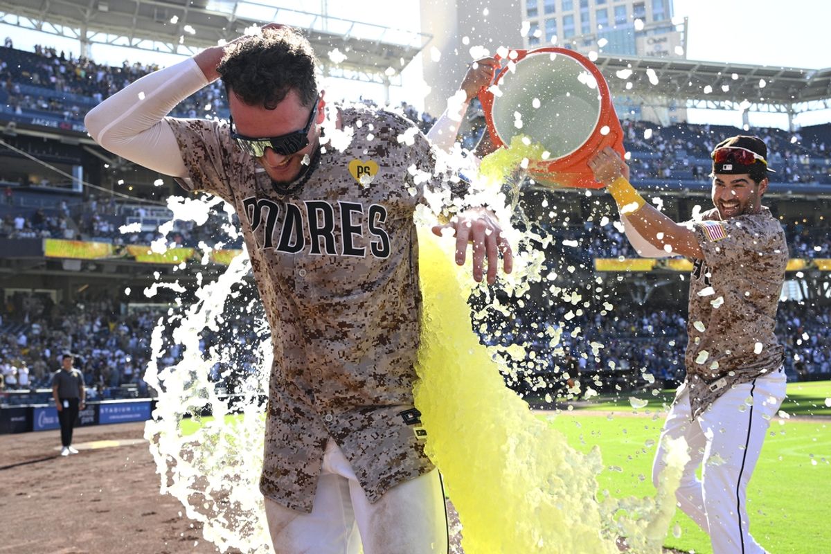 Aug 25, 2024; San Diego, California, USA; San Diego Padres center fielder Jackson Merrill (3) is doused by third baseman Tyler Wade (14) after hitting a walk-off home run against the New York Mets the at Petco Park. Mandatory Credit: Orlando Ramirez-USA TODAY Sports