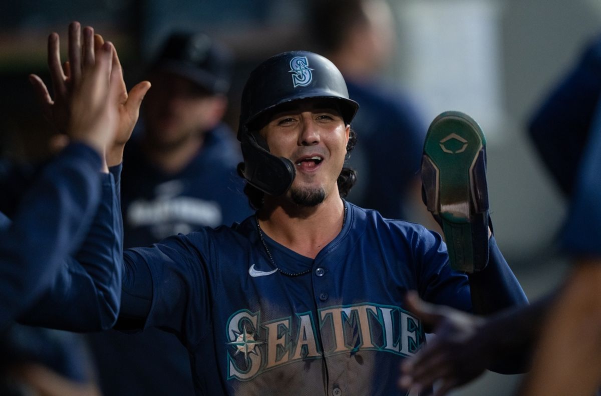 Aug 26, 2024; Seattle, Washington, USA; Seattle Mariners third baseman Josh Rojas (4) celebrates in the dugout after scoring a run during the fourth inning against the Tampa Bay Rays at T-Mobile Park. Mandatory Credit: Stephen Brashear-Imagn Images