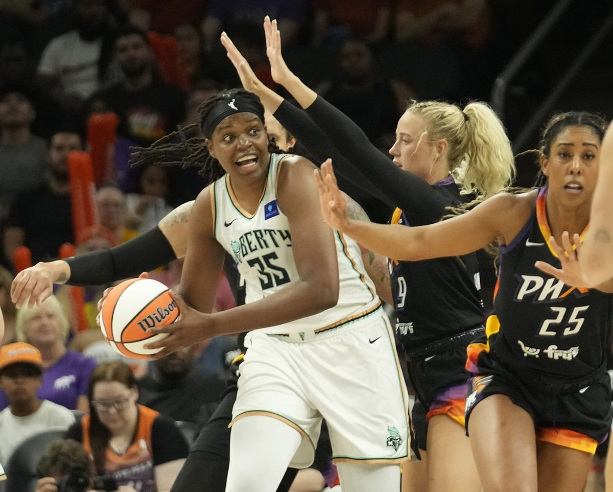 New York Liberty forward Jonquel Jones (35) looks to pass against Phoenix Mercury guard Sophie Cunningham (9) during the second quarter at Footprint Center on Aug. 26, 2024, in Phoenix.