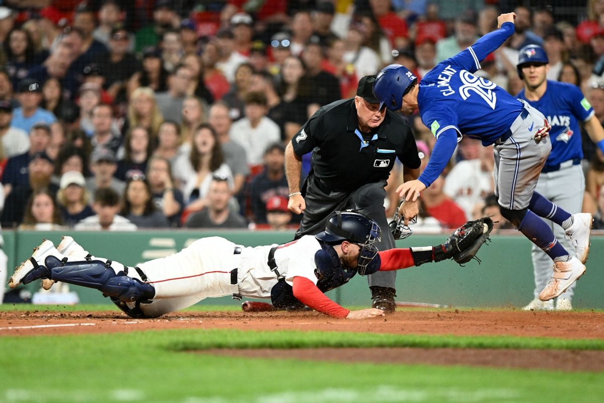 Aug 27, 2024; Boston, Massachusetts, USA; Boston Red Sox catcher Danny Jansen (28) tags out Toronto Blue Jays third baseman Ernie Clement (28) at home during the fourth inning at Fenway Park. Mandatory Credit: Brian Fluharty-USA TODAY Sports