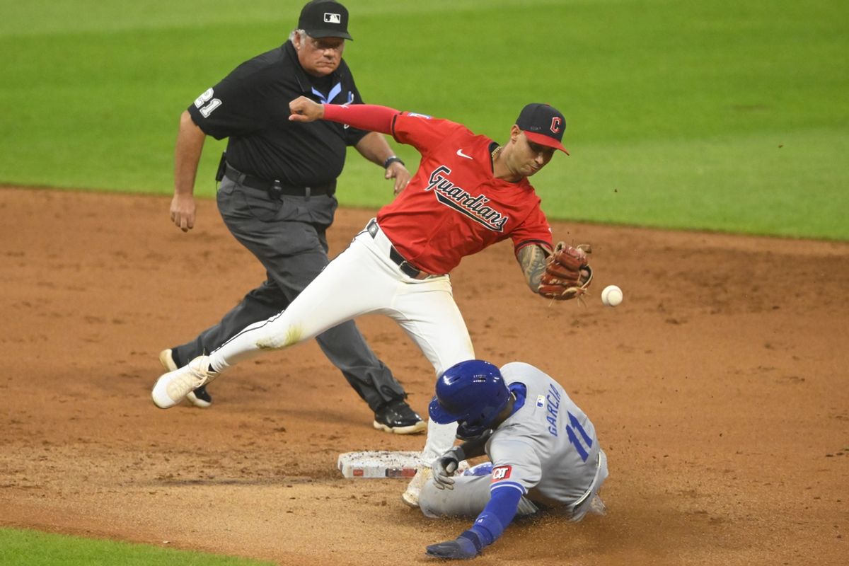 Aug 27, 2024; Cleveland, Ohio, USA; Kansas City Royals second baseman Maikel Garcia (11) steals second base beside Cleveland Guardians shortstop Brayan Rocchio (4) in the fifth inning at Progressive Field. Mandatory Credit: David Richard-USA TODAY Sports